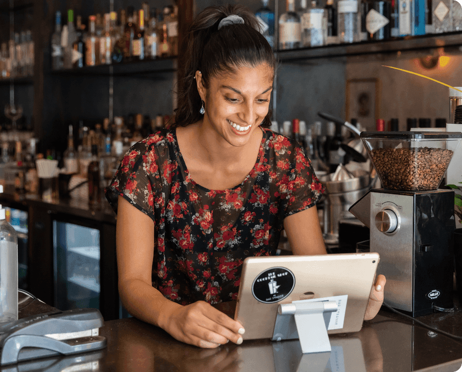 Ready to get started. Restaurant employee using 7shifts scheduling software on tablet.